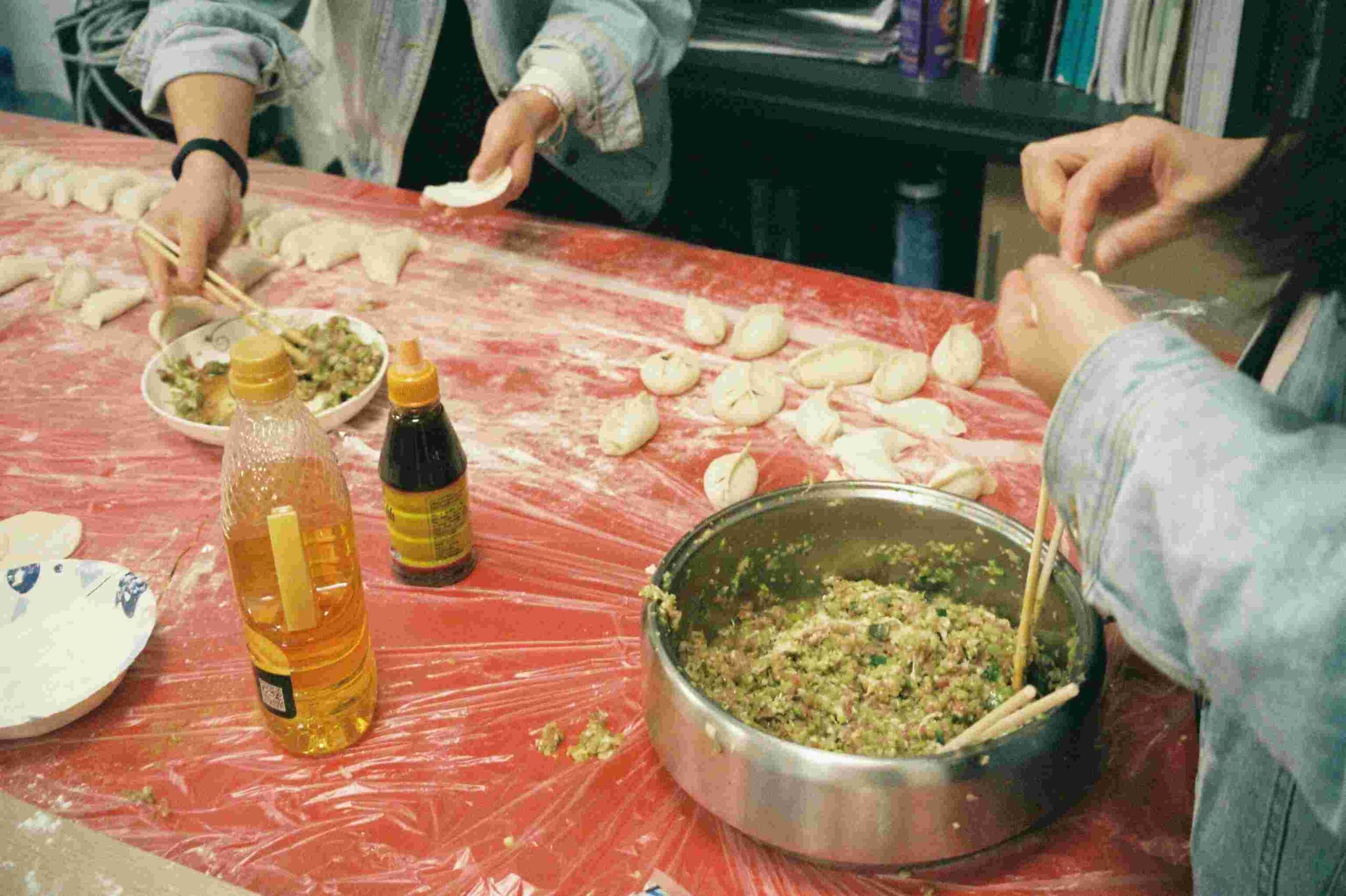 Women making momos during a cooking class on an all-women Nepal tour.