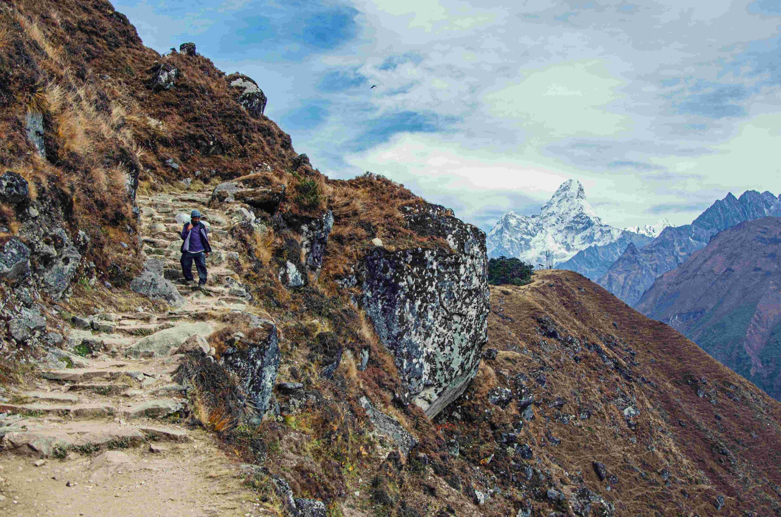 Trekker climbing long stone stairs in Annapurna Base Camp Trek